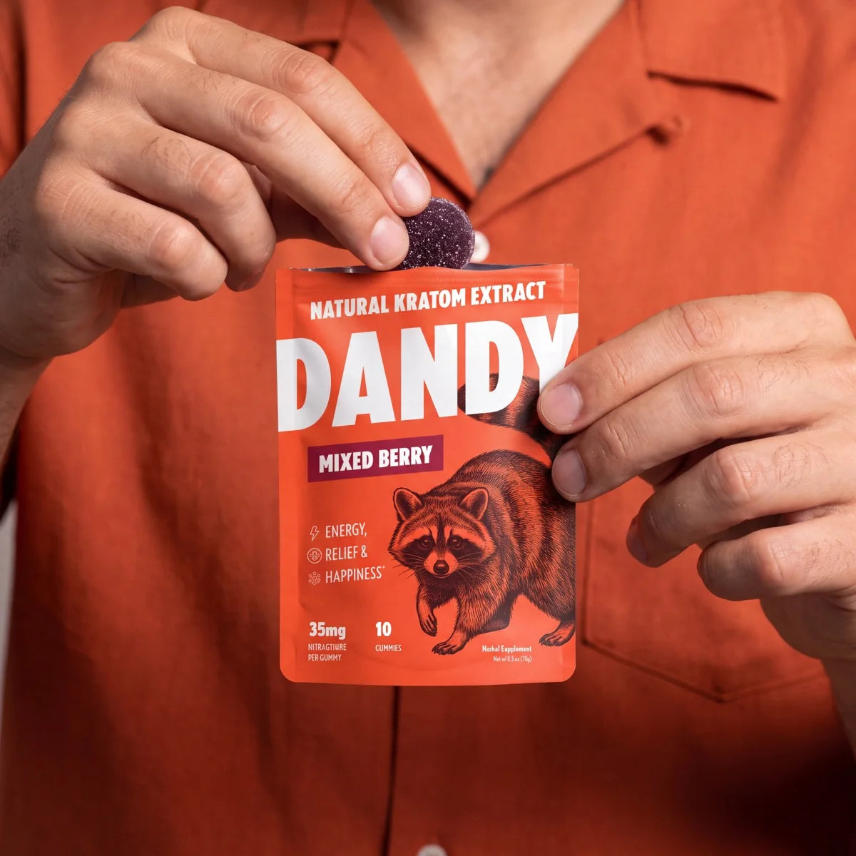 Dandy mixed berry gummy held above the pouch