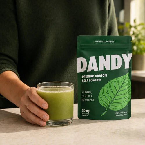 Dandy premium kratom leaf powder pouch beside a stirred glass