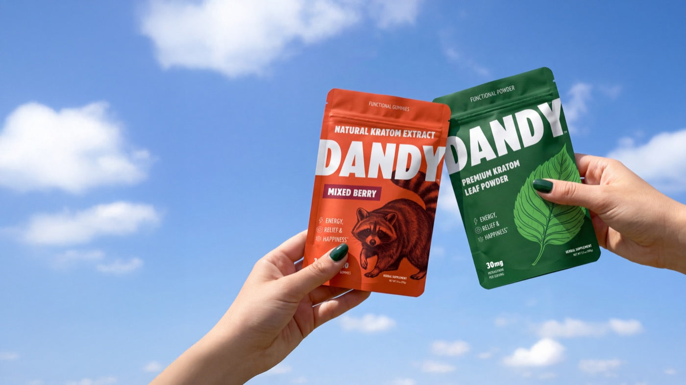 Dandy gummy and powder pouches held against a blue sky