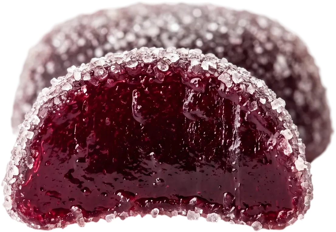A Dandy gummy bitten in half, glossy berry-red inside with a sugar rim
