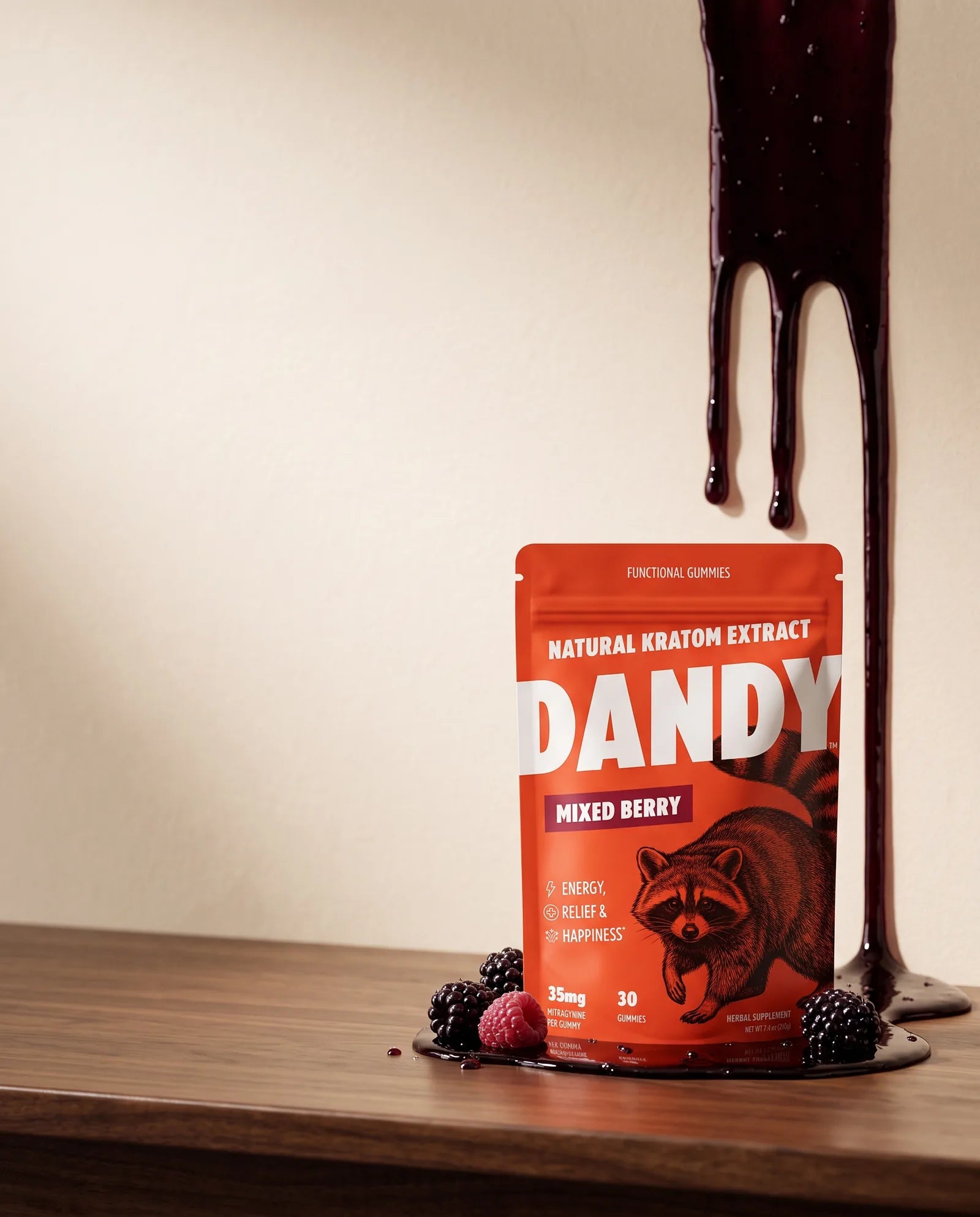 Berry syrup dripping down a cream wall behind the Dandy Mixed Berry pouch on a candy counter