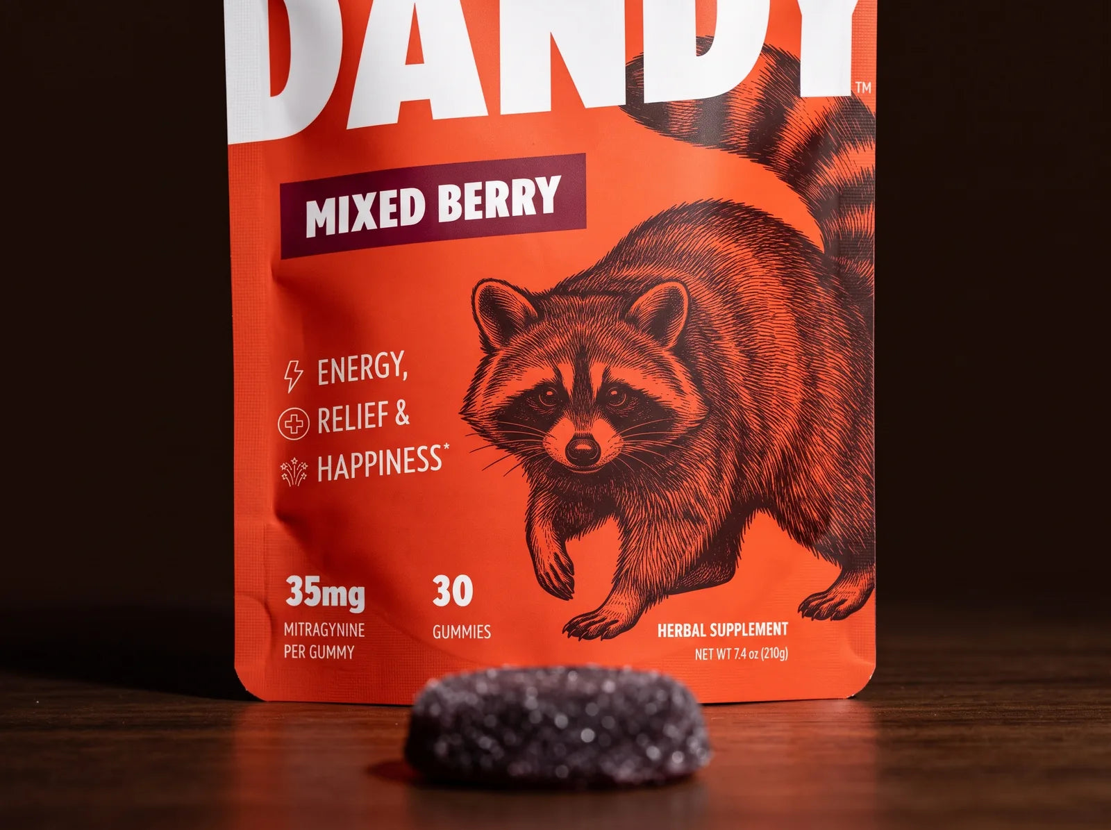 The Dandy Mixed Berry pouch, label forward, with one gummy in front