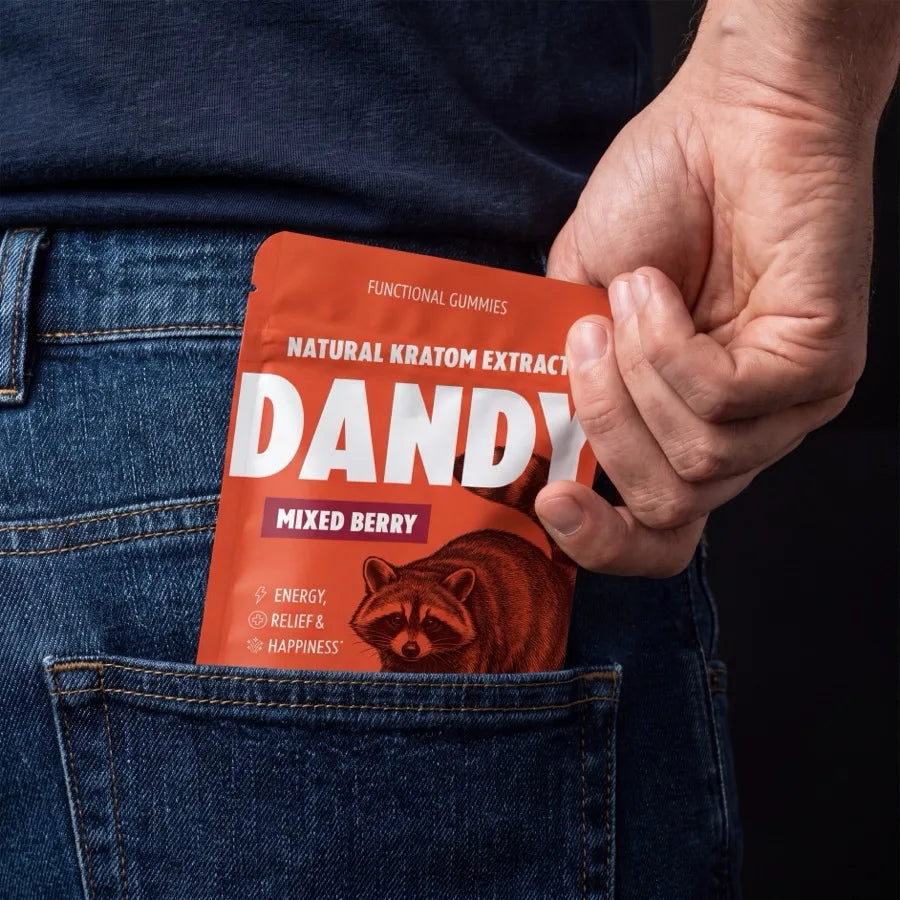 A hand pulling a Dandy Mixed Berry pouch out of a jeans back pocket